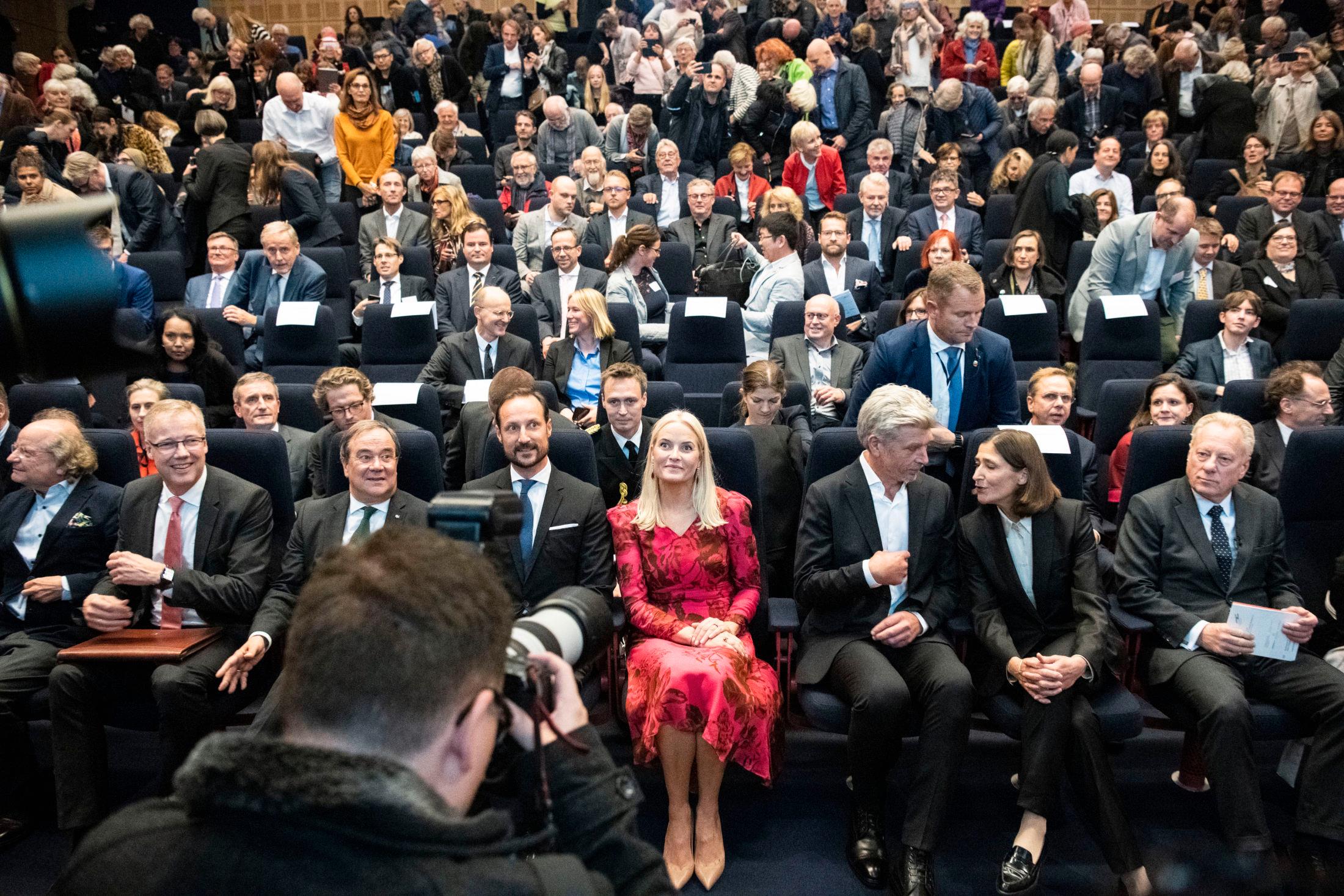 BLIKKFANG: Mette-Marit i rød kjole sammen kronprins Haakon og Karl Ove Knausgård under åpningen av Munch-Knausgård-utstillingen. Foto: Ola Vatn, VG.