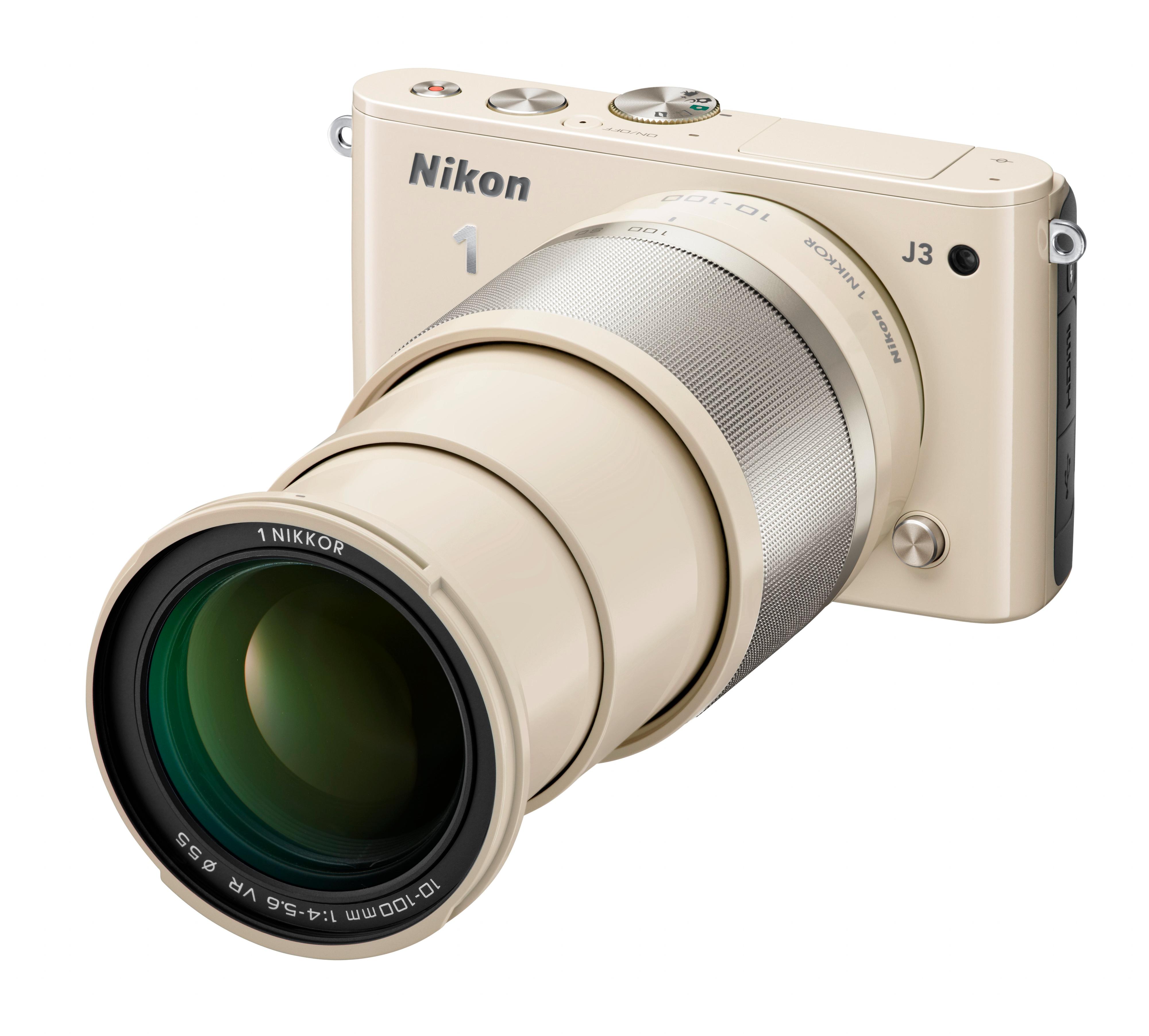 Beige Nikon 1 J3 med 1 Nikkor 10 - 100 mm.
