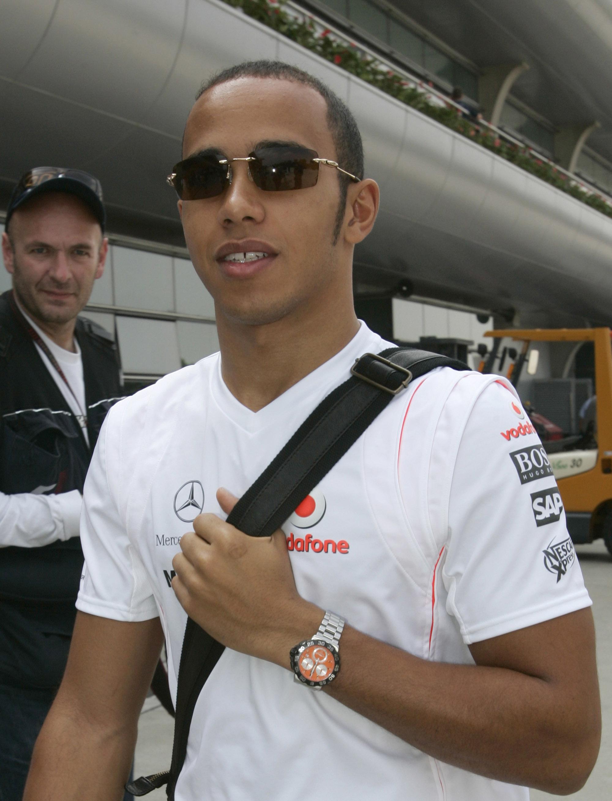 TEAM-TRØYE: I begynnelsen av Formel 1-karrieren valgte Hamilton ofte å kle seg i lagets egne T-skjorter i forbindelse med løp. Her er han i 2007, med tidsriktige solbriller. 