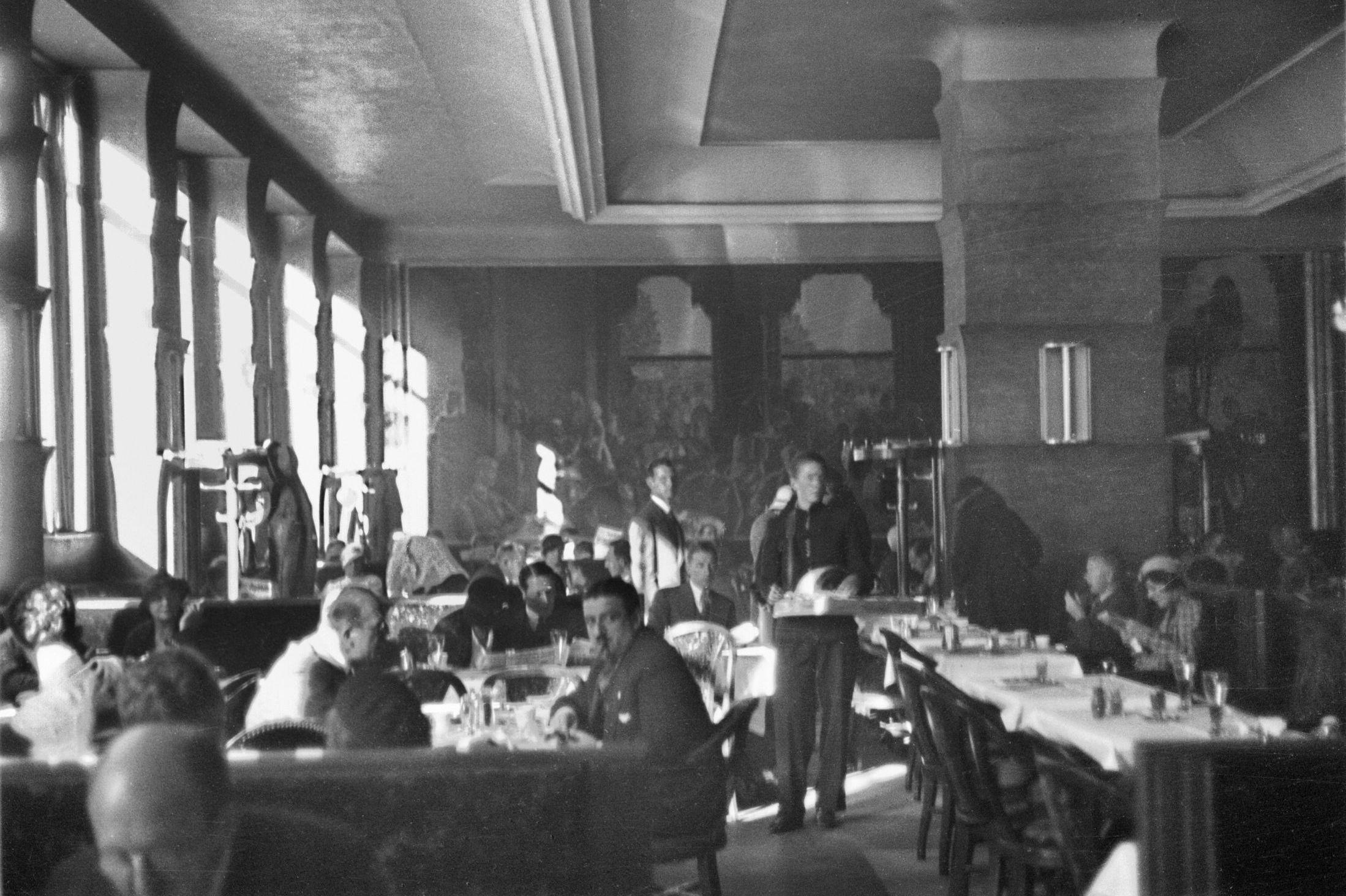 KULTURMINNER: I bakgrunnen av kafémylderet henger det kjente maleriet Kristiniabohemen. Bildet er fra 1933. Foto: Ukjent fotograf/Oslo Museum